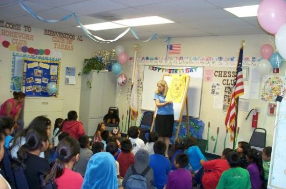 Mary-Pat Gonzalez reads to the children during story time at the Oak View Library's 15th anniversary celebration